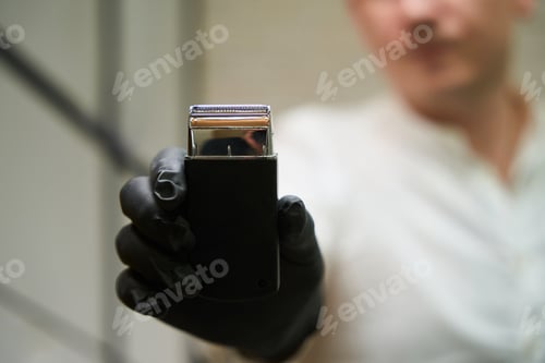 Preview: Barber man holding a clipper in his hands