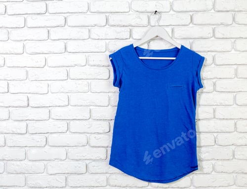 Preview: Blue Top on Hanger in Front of Brick Wall