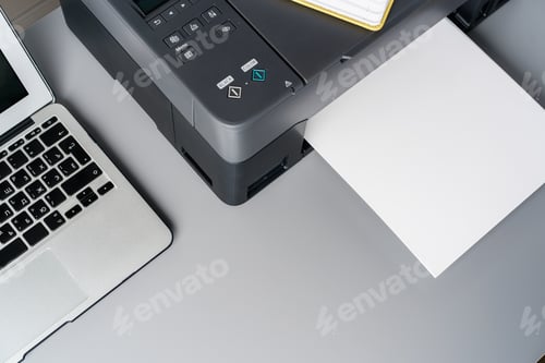 Preview: New modern printer and laptop in the office on table