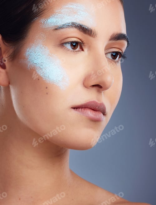 Preview: Studio shot of a beautiful young woman posing against a grey background
