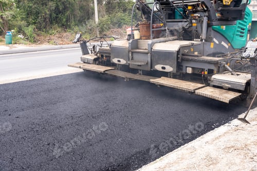 Preview: Machines are pouring asphalt to build roads for cars.
