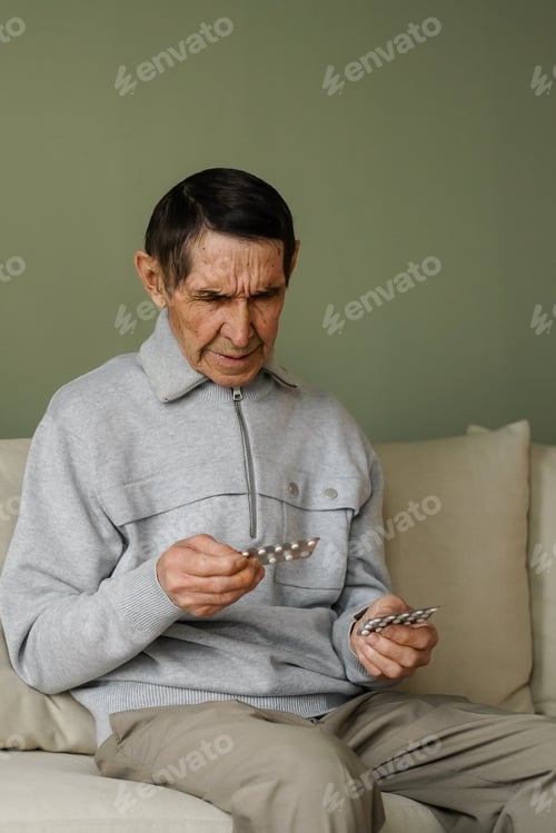 Preview: Senior adult man holding painkiller pills on male hand. treatment concept