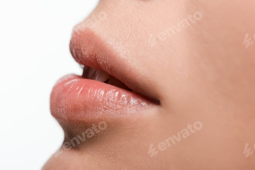 Preview: close up of young woman with shiny lip gloss on lips