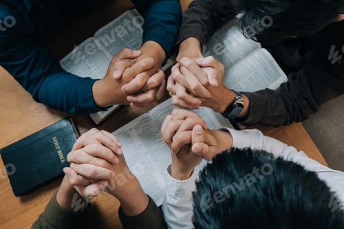 Preview: Group of christian people reading the Holy Bible to pray and worship God together.
