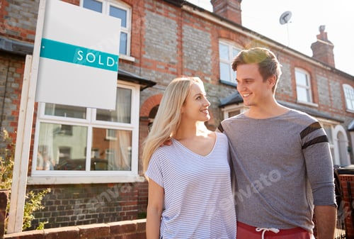 Preview: Excited Couple Standing Outside New Home With Sold Sign