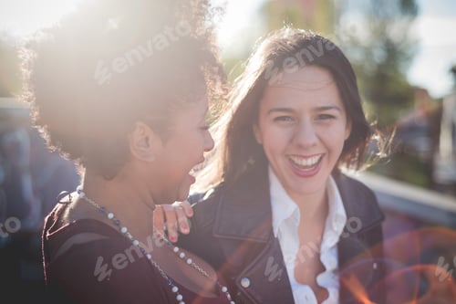 Preview: two multiethnic beautiful young woman black and white having fun