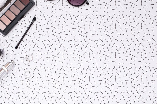 Preview: Cosmetics and Rings on Patterned White Background