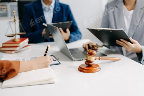 Preview: business people and lawyers discussing contract papers sitting at the table.