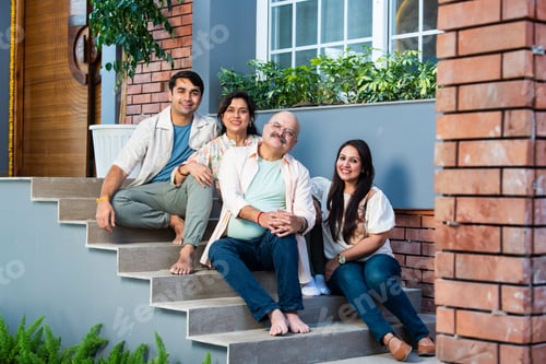 Preview: Outdoor portrait of cheerful Indian family sitting on stairs