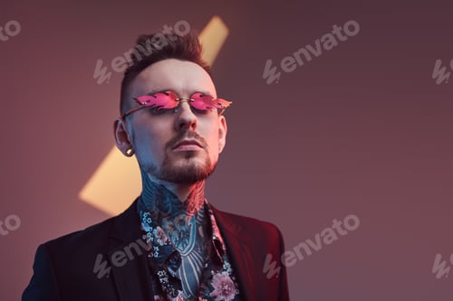 Preview: Caucasian macho in black suit with shirt in dark and colourful room