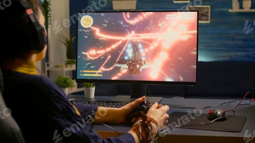 Preview: Over shoulder of focused cyber player wearing headset