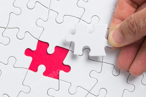 Preview: Hand putting the last piece of white puzzle for business concept or content background