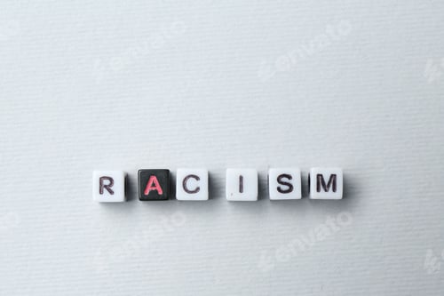 Preview: Word Racism made with beads on light grey background, top view