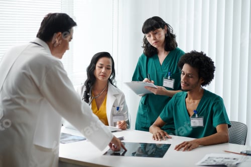 Preview: Doctor Discussing Document with Team