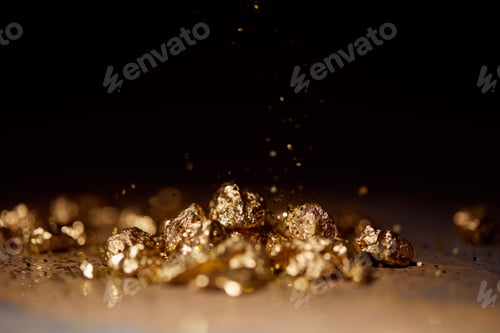 Preview: selective focus of golden stones on brown marble surface with blurred black background