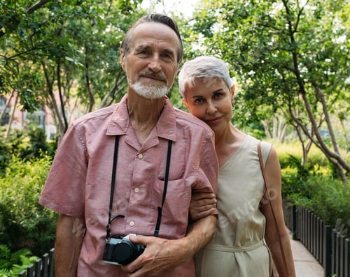 Preview: Portrait of two aged people looking at a camera in the park