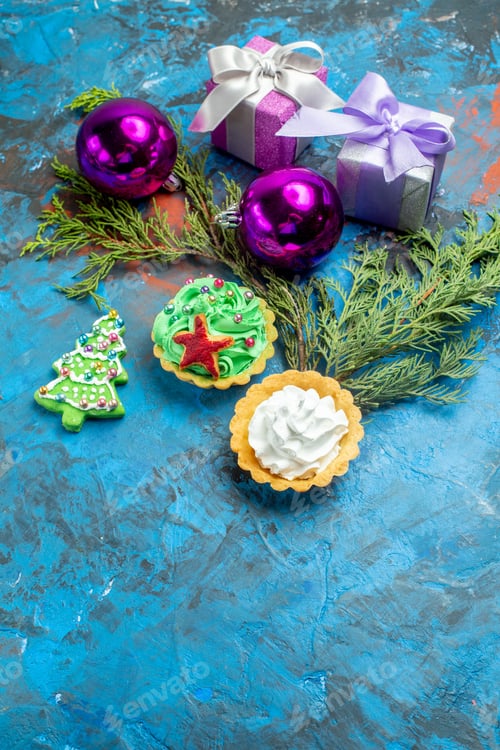 bottom view small tarts small gifts pine branches on blue background copy space