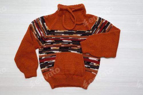 Preview: Knitted children's sweater on a white background
