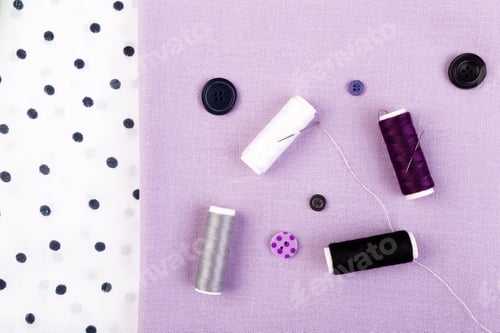 Preview: Items for sewing clothes. Sewing buttons, spools of thread and cloth. Top view.