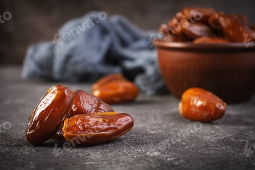 Preview: Dried date fruit in bowl on wooden background. Delicious dates fruit