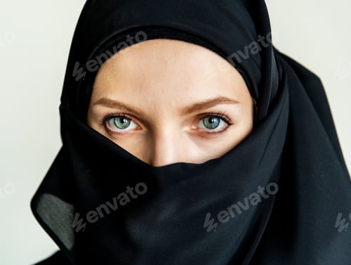 Preview: Woman in a Black Hijab with Intense Eyes