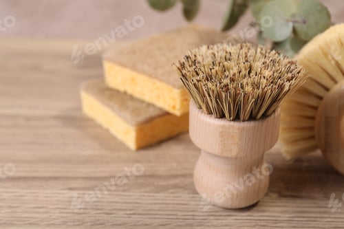 Preview: Small cleaning brush on wooden table, closeup. Space for text