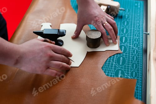 Preview: Leather cutting with pattern. Artisan uses templates for precise hide cutting