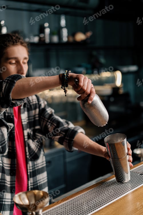Preview: The bartender throws ice into the shaker the first steps in making a cocktail