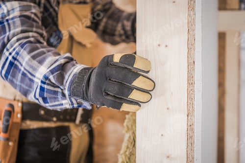 Preview: Close Up Of Male Worker Adding Insulation To Walls During House Renovation.