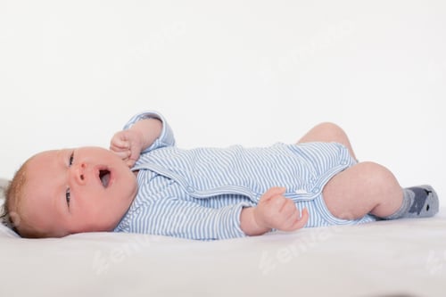 Preview: Sweet Infant Lying on Back in Blue Outfit