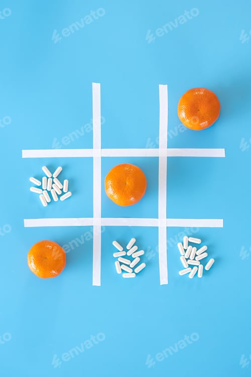 Preview: Tangerines and pills on a blue background, flat lay.