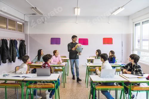 Preview: Geography teacher showing globe to elementary school students