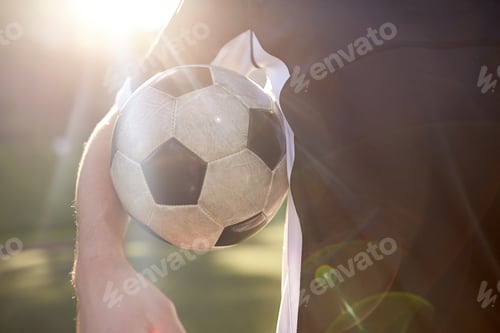 Preview: close up of soccer player with ball on field
