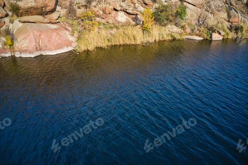Preview: A smooth shining stream flows among large boulders