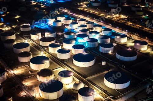 Preview: Aerial view of oil refinery storage tanks illuminated at night, Los Angeles, California, USA