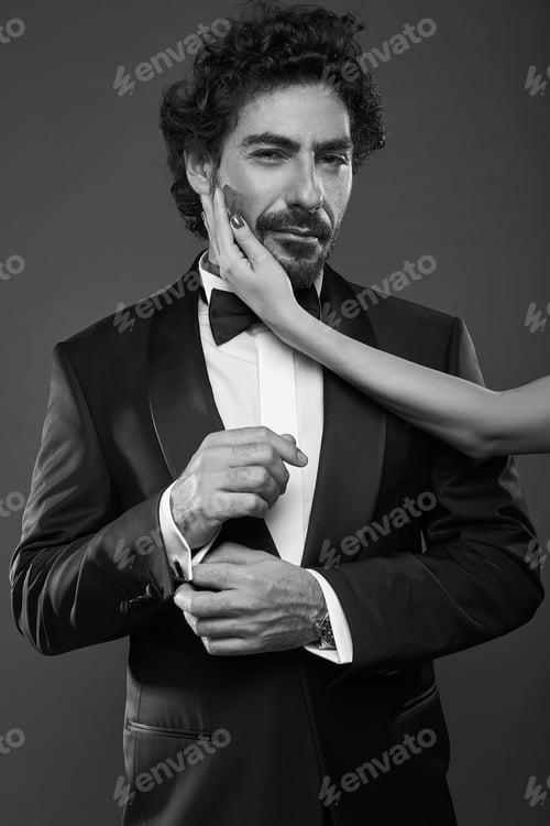 Preview: Fashionable Portrait Of Elegant Sexy Couple In Studio. Brutal Man In Suit With Woman'S Hand