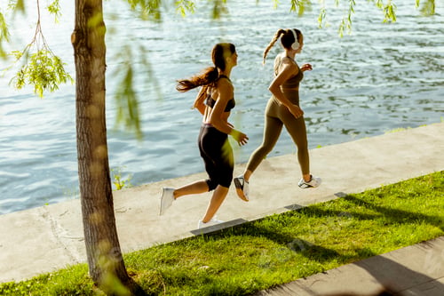 Preview: Young woman taking running exercise by the river promenade