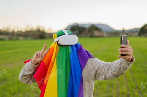 Preview: Man with virtual reality glasses and an LGBT flag taking a selfie