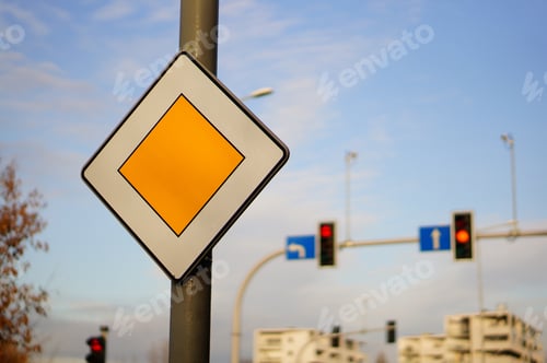 Preview: Closeup shot of a road sign on a column indicating the priority for the road