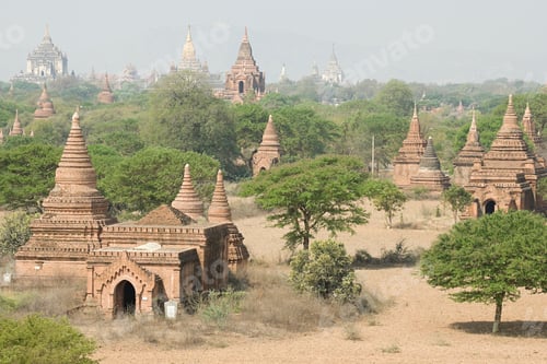 Preview: Ancient temples amidst a green landscape under a hazy sky