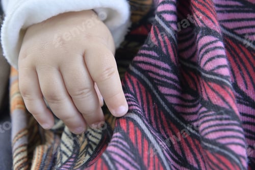 Preview: Closeup shot of the baby's hand on a blanket