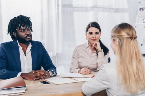 Preview: Selective focus of multiethnic recruiters conducting job interview with employee in office