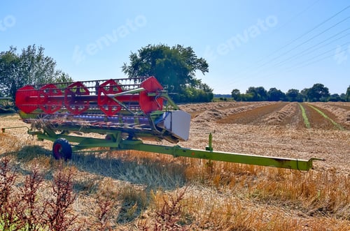 Preview: Harvester machine harvesting fresh crops on a farm field during a sunny day