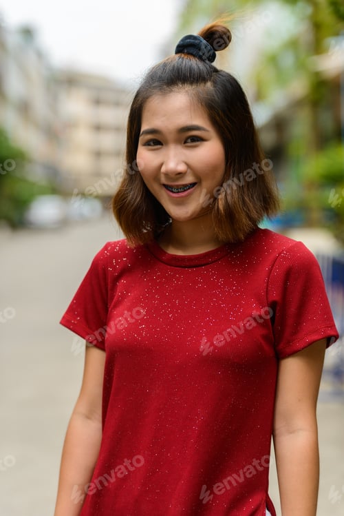 Preview: Portrait of young Asian woman with short hair outdoors