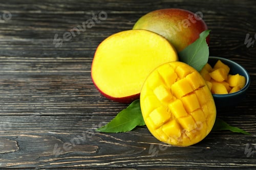 Preview: Tasty ripe mango fruit on wooden table