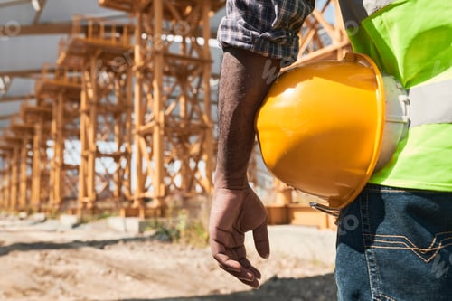 Building worker analyzing project plan