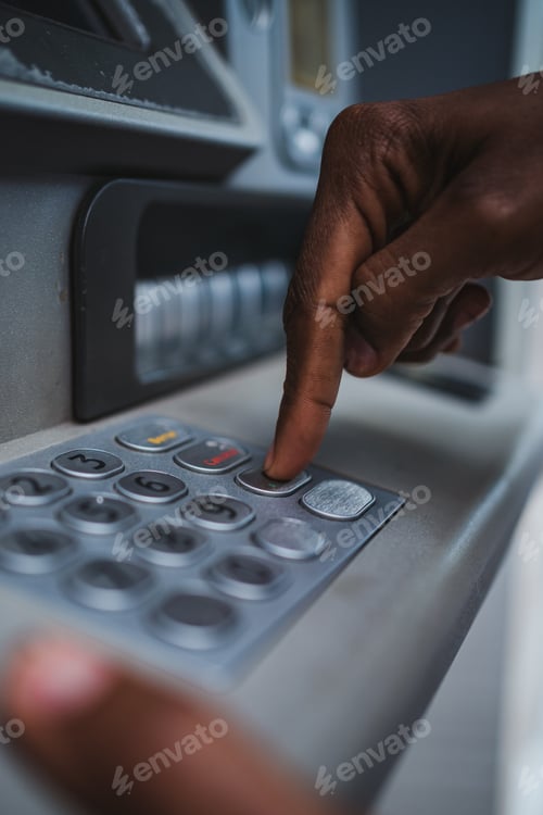 Preview: Man using ATM keyboard to check bank account