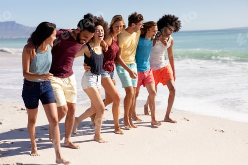 Preview: Multi-ethnic group of male and female standing on the beach