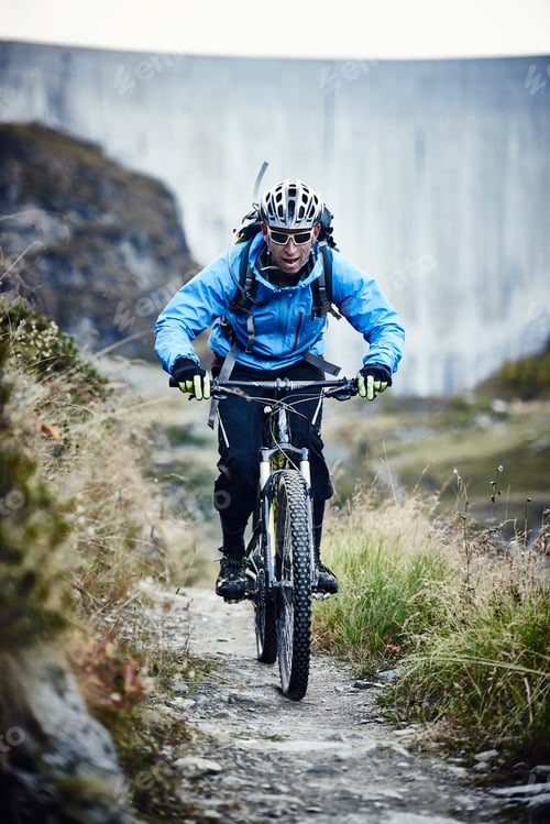 Preview: Mountain biker on dirt track, Valais, Switzerland