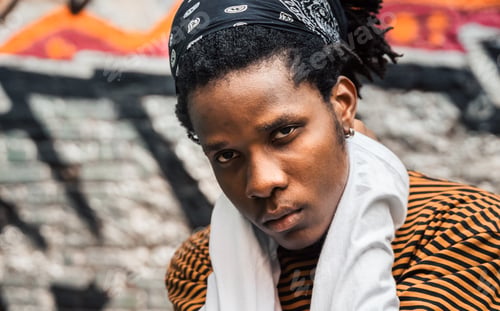 Preview: Portrait of young handsome stylish black man with natural hair afro dreadlocks. Afroamerican guy. St